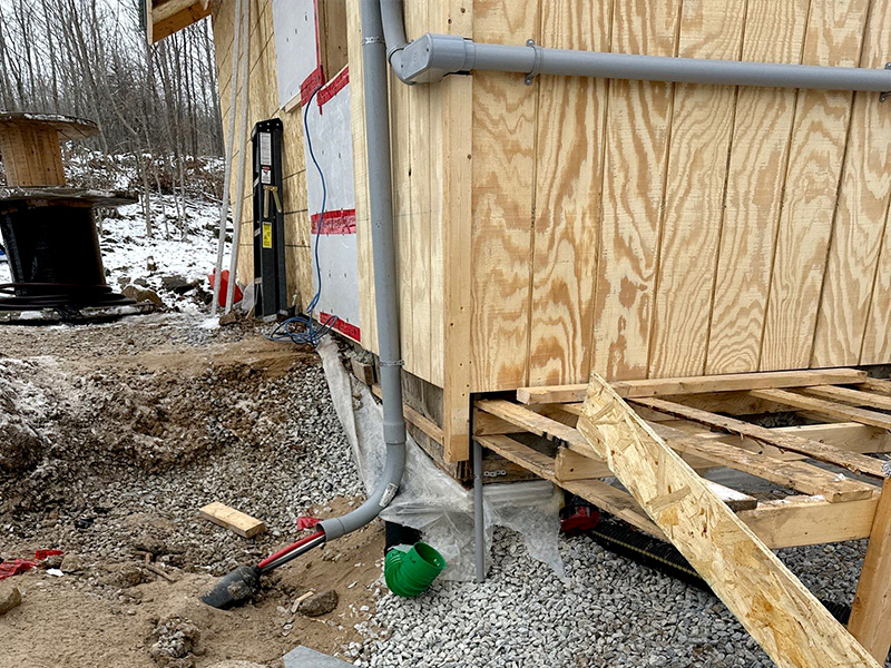 Exterior conduit and service routing at a rural new-build structure